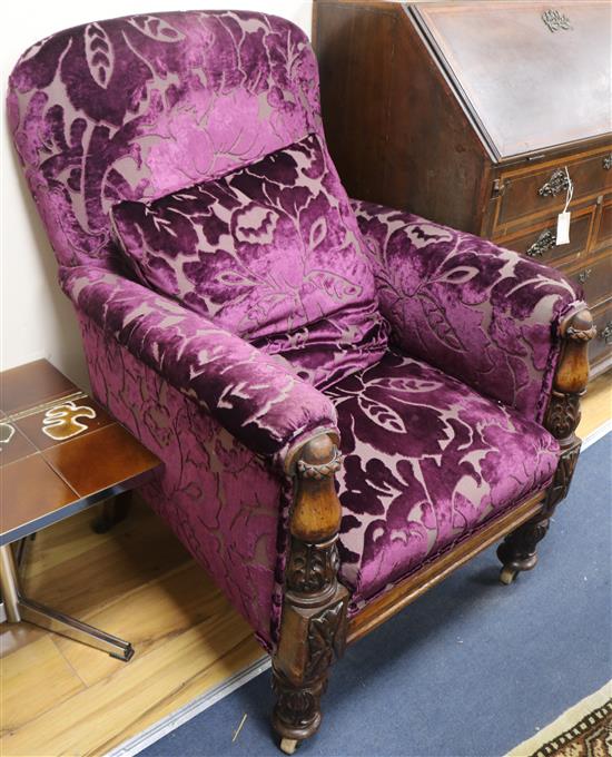 A Victorian carved mahogany armchair, upholstered in purple fabric